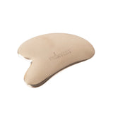 Beige facial massage tool with 'Skinvest' branding on a white background