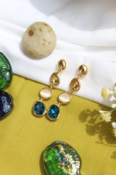 Blueberry Flame Earrings on a white and green fabric background