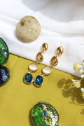Blueberry Flame Earrings on a white and green fabric background