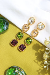 Moonkiss Drop Earrings on a yellow fabric background with flowers