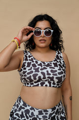 Woman wearing a cow print swimsuit