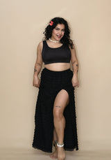 Woman wearing a black bikini top and a long skirt