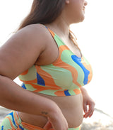 Asian woman wearing colorful swimsuit with abstract print