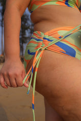 Plus size woman wearing colorful bikini bottom