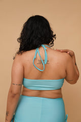Plus size woman wearing a turquoise bikini set