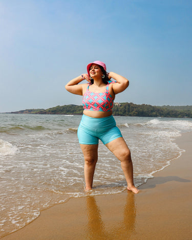 Woman in a colorful top and blue shorts