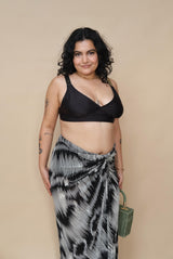 Woman wearing a black top and patterned skirt