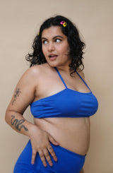 Woman wearing a blue bikini halter neck top