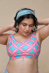 Woman wearing a pink and blue patterned round neck top
