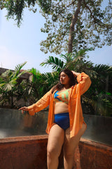 Woman in a blue bikini and orange cover-up