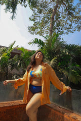 Woman in a colorful bikini and orange cover-up