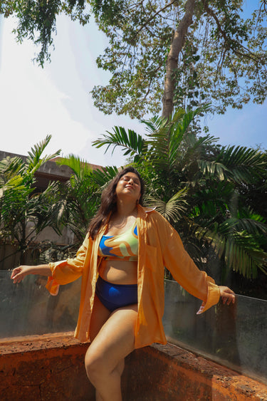 Woman in a colorful bikini and orange cover-up