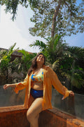 Woman in a colorful bikini and orange cover-up