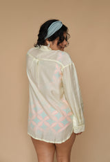 Woman wearing a sheer lime shirt with geometric patterns