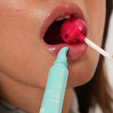 Person applying a turquoise lip balm to their lips with a red lollipop.