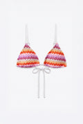 A two-piece triangle bikini set with a vibrant chevron pattern in pink, orange, purple, and white, featuring white strings and thin shoulder straps, displayed on a clean white background.