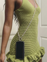 Green crochet dress with a black phone case hanging from a chain.