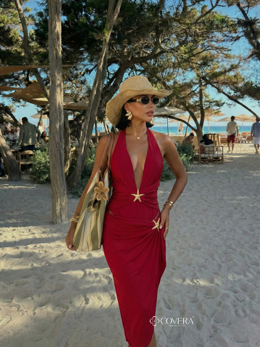 Monokini and skirt set in deep red worn at beach resort