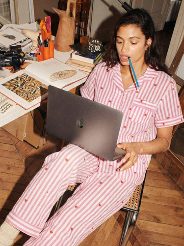Model wearing pink stripe heart cotton nightsuit lounging at home – women’s sleepwear