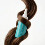 Skinvest Hairloom bottle with brown hair on a white background