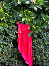 Red-pink floral sarong displayed hanging to show print – women’s resortwear