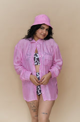 Woman wearing a pink shirt with a cow print top and shorts 