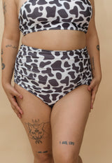 Woman wearing a cow print bikini set 