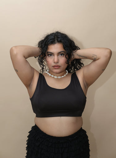 Woman wearing a black top and black skirt 