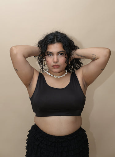 Woman wearing a black top and black skirt 