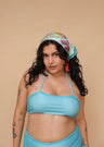 Woman wearing a blue bikini and colorful headscarf 