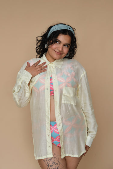 Woman wearing a sheer lime shirt over a colorful bikini set