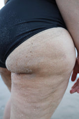 Close-up of a woman wearing a black swimsuit