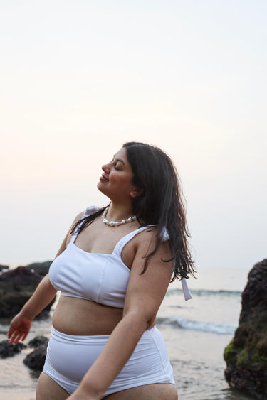 Curvy woman in a white swimsuit 