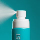 Blue spray bottle with white nozzle against a teal background