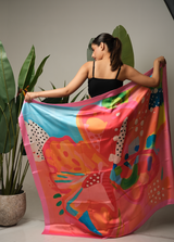 Oversized printed sarong displayed open to show full tropical print – women’s resortwear