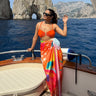Pina Colada printed sarong styled as beach cover-up on boat – women’s resortwear