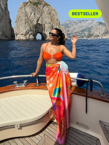 Pina Colada printed sarong styled as beach cover-up on boat – women’s resortwear
