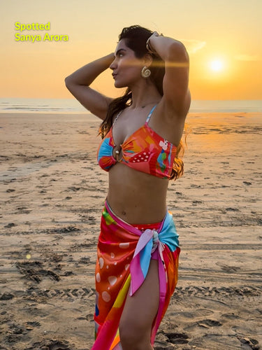 Pina Colada sarong styled as wrap skirt on beach – women’s resortwear