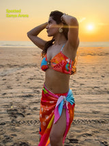 Pina Colada sarong styled as wrap skirt on beach – women’s resortwear