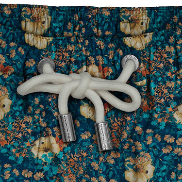 House of Malabaar boy's swim shorts with tropical leaves and hibiscus flowers.