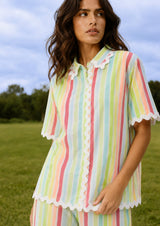 Woman wearing a colorful striped dress in an outdoor setting